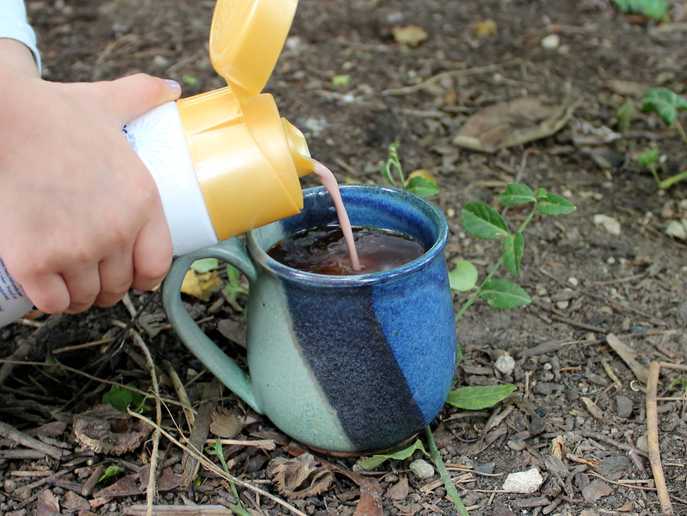 pouring International Delight S’mores coffee creamer into a mug