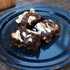 Thumb: brownies with graham cracker crust, melted marshmallows on top, and a drizzle of chocolate syrup
