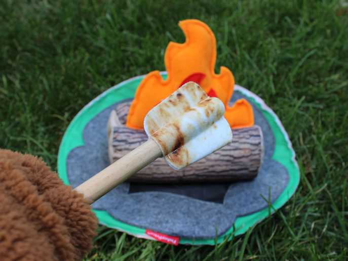 bear hands roasting marshmallow over Fisher-Price S’more Fun Campfire
